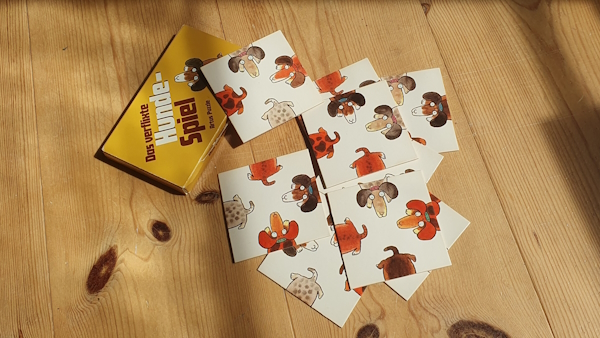 A picture of the box of the puzzle, together with the tiles spread out in unordered fashion.